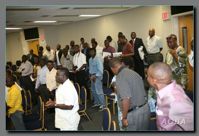 <small>The headmaster receiving a standing ovation after his address</small>